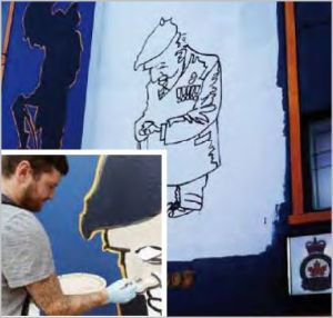 Nick Gregson at work on the Veterans Memorial Mural.