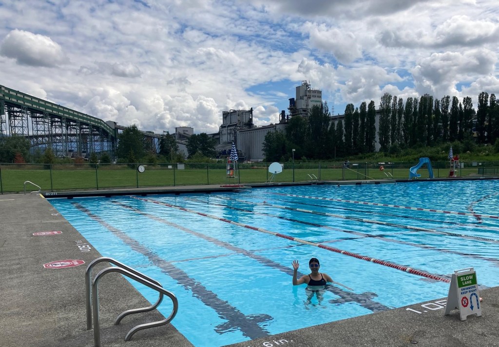Photo of swimmer in the slow lane at New Brighton Pool with the working waterfront in the background. Bike then swim at New Brighton Pool.